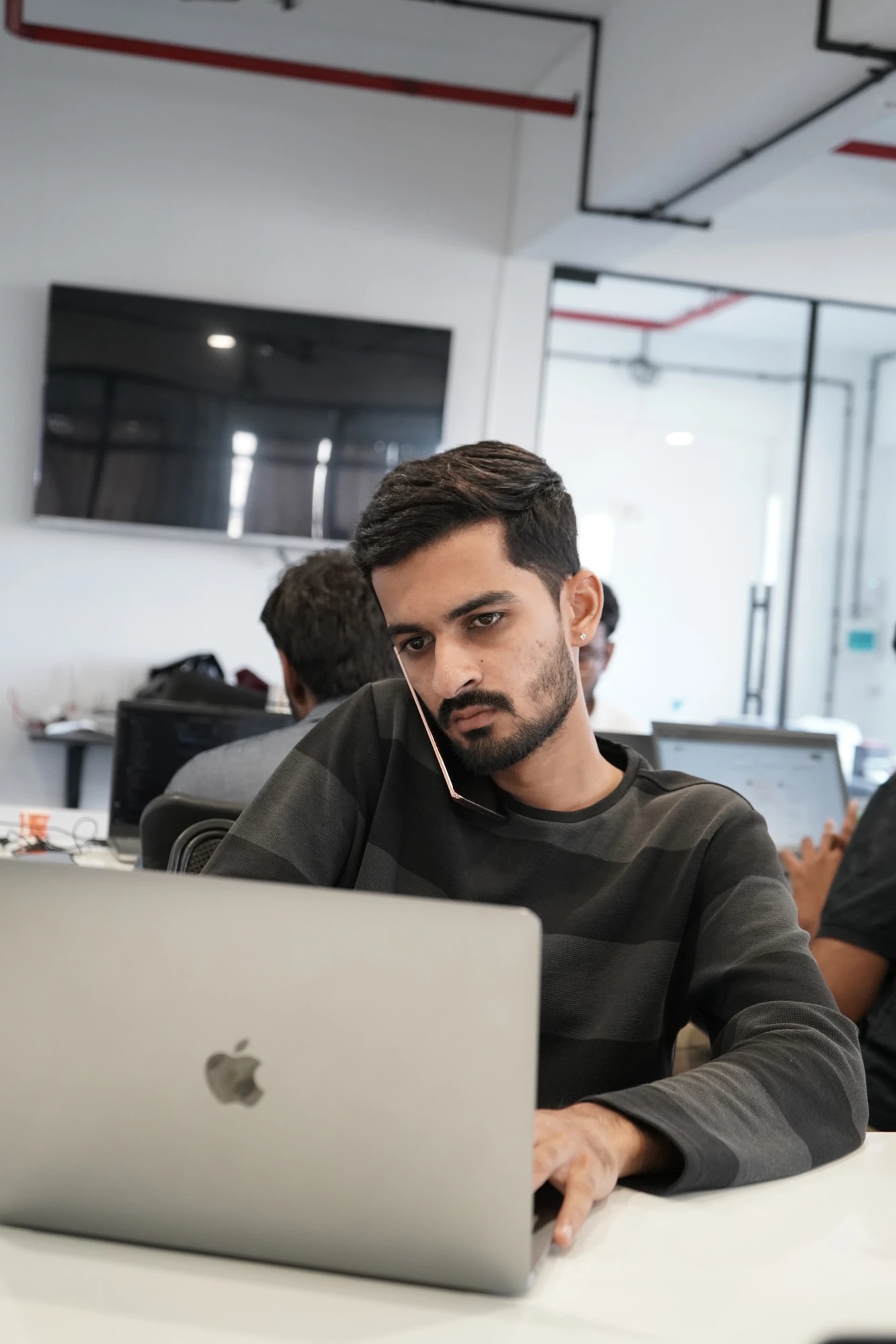 A Kalaa team member on a phone call while working at a laptop